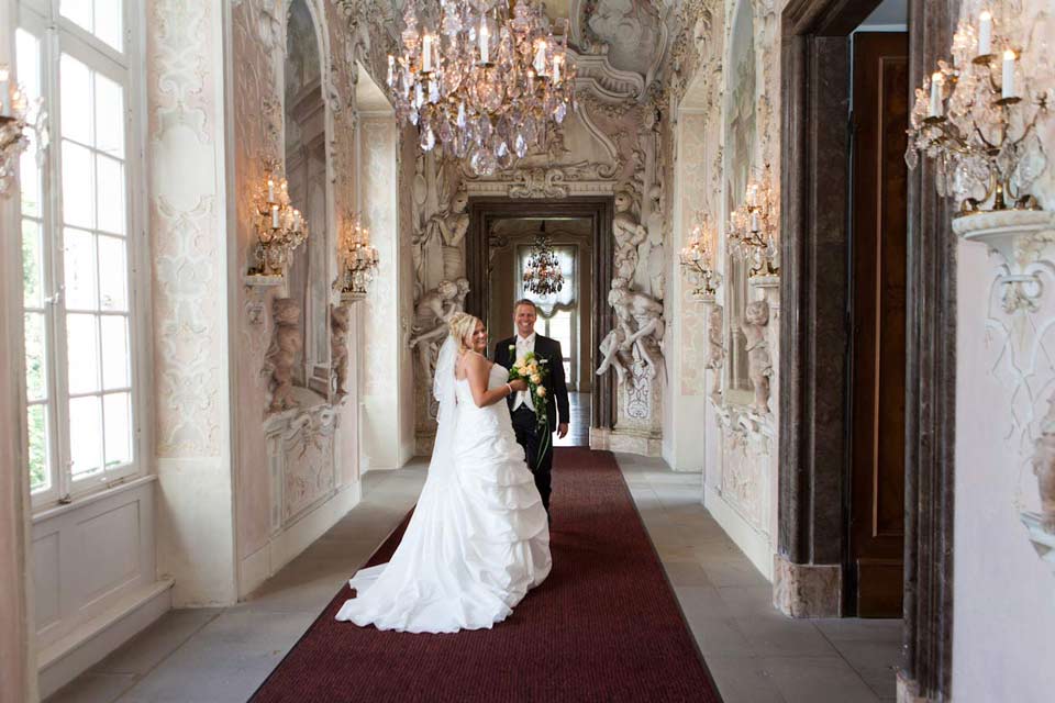 Dieses Paar wollte in einem Schloss fotografiert werden. Die romantische Kulisse war für den Hochzeitsfotografen Stuttgart ideal. Die meisten Bräute müssen sich seitlich stellen, damit sie auf dem Hochzeitsfoto schlanker aussehen.